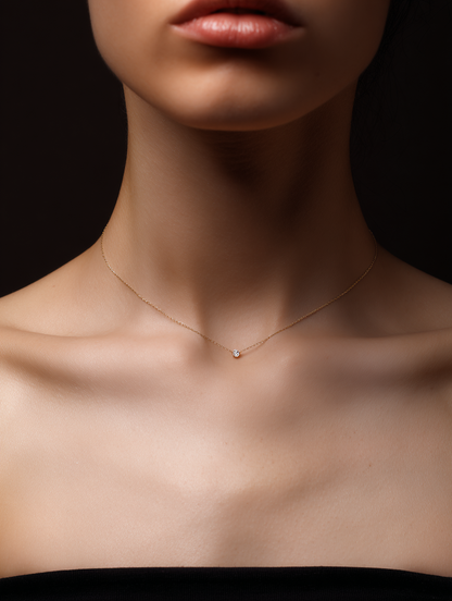 girl wearing a fine gold necklace with a bezel set diamond frontal view